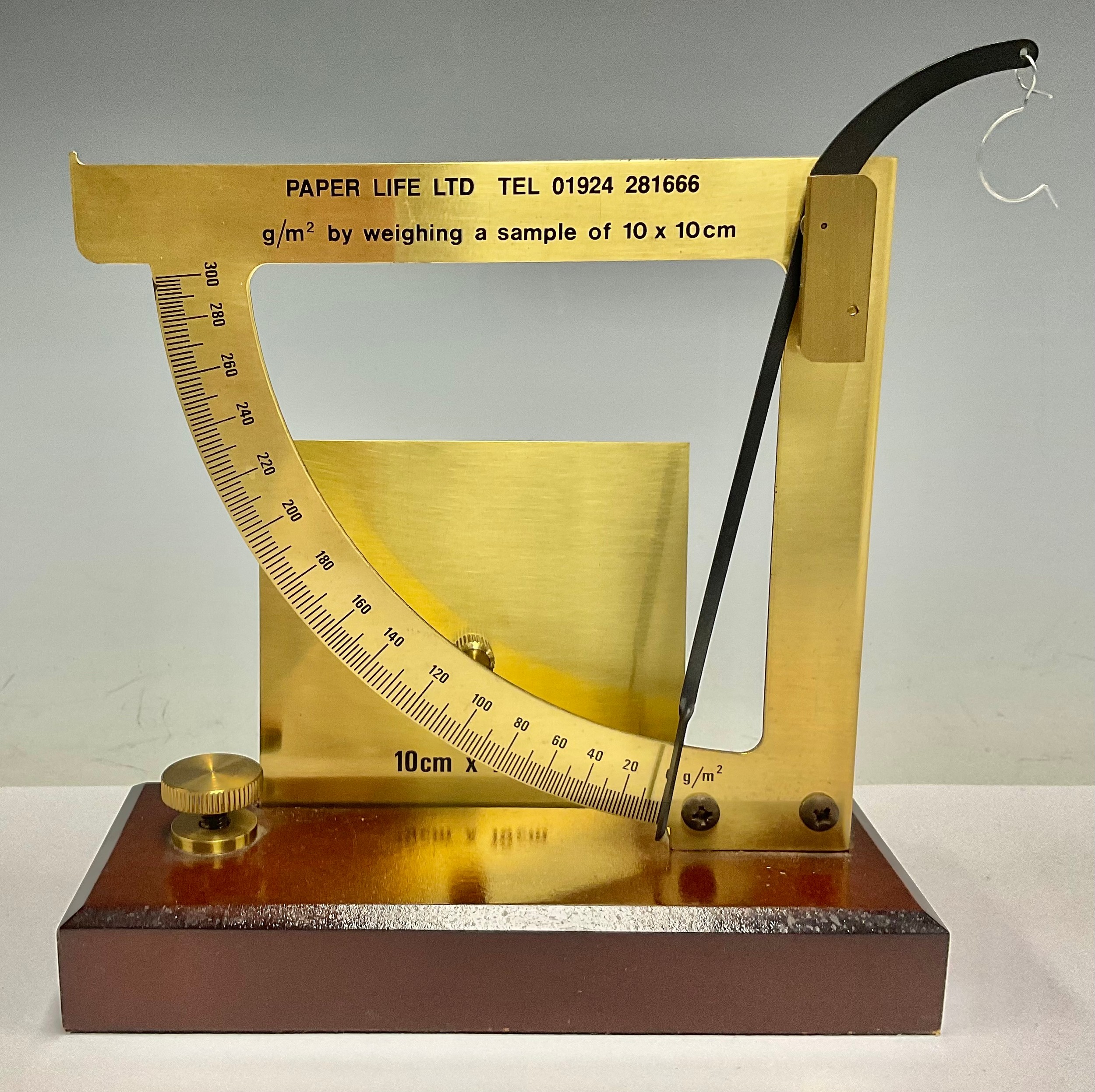 A brass paper scale balance, Paper Life Ltd, g/m2 by weighing a sample of 10 x 10cm, mahogany