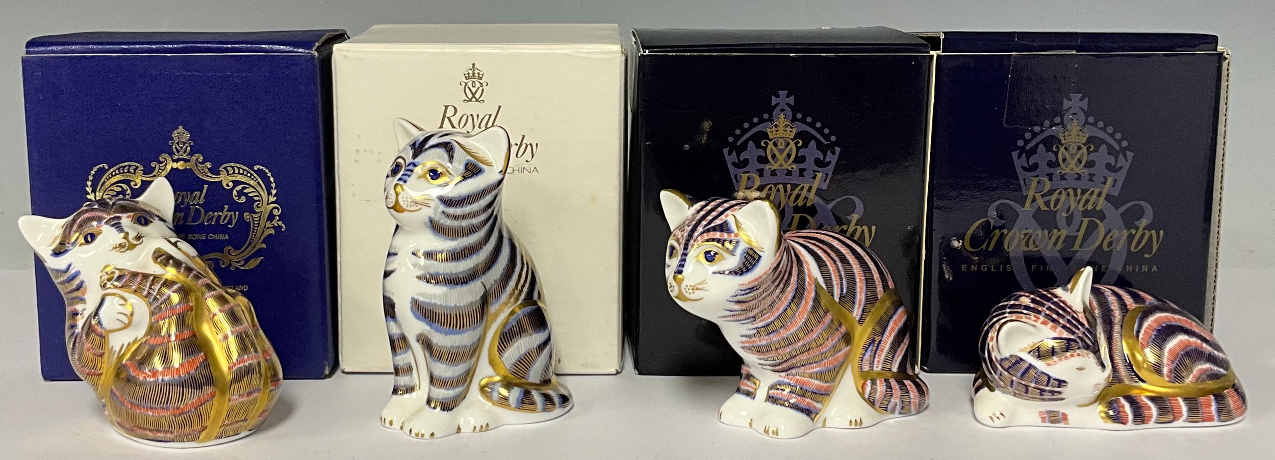 A set of three Royal Crown Derby paperweights, Playful Kitten, Sleeping Kitten and Sitting Kitten,