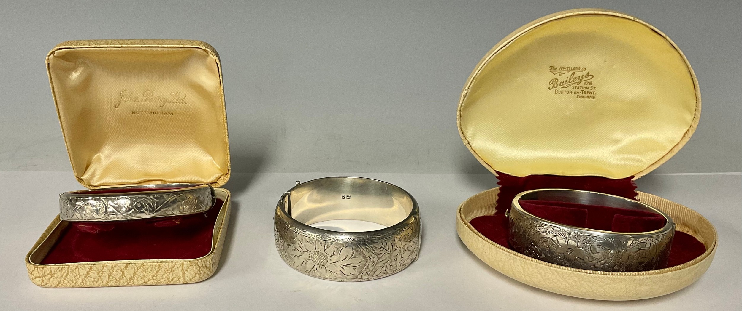 A silver hinged bangle, Birmingham 1964; two others similar, 89.9g gross,