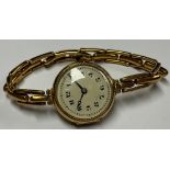 A lady's 18ct gold watch, cream enamel dial with Arabic numerals, the case interior marked 18 and .