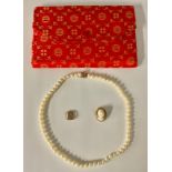 A single strand of cultured pearls, 14k gold clasp, marked 585, made in China, with red pouch; an