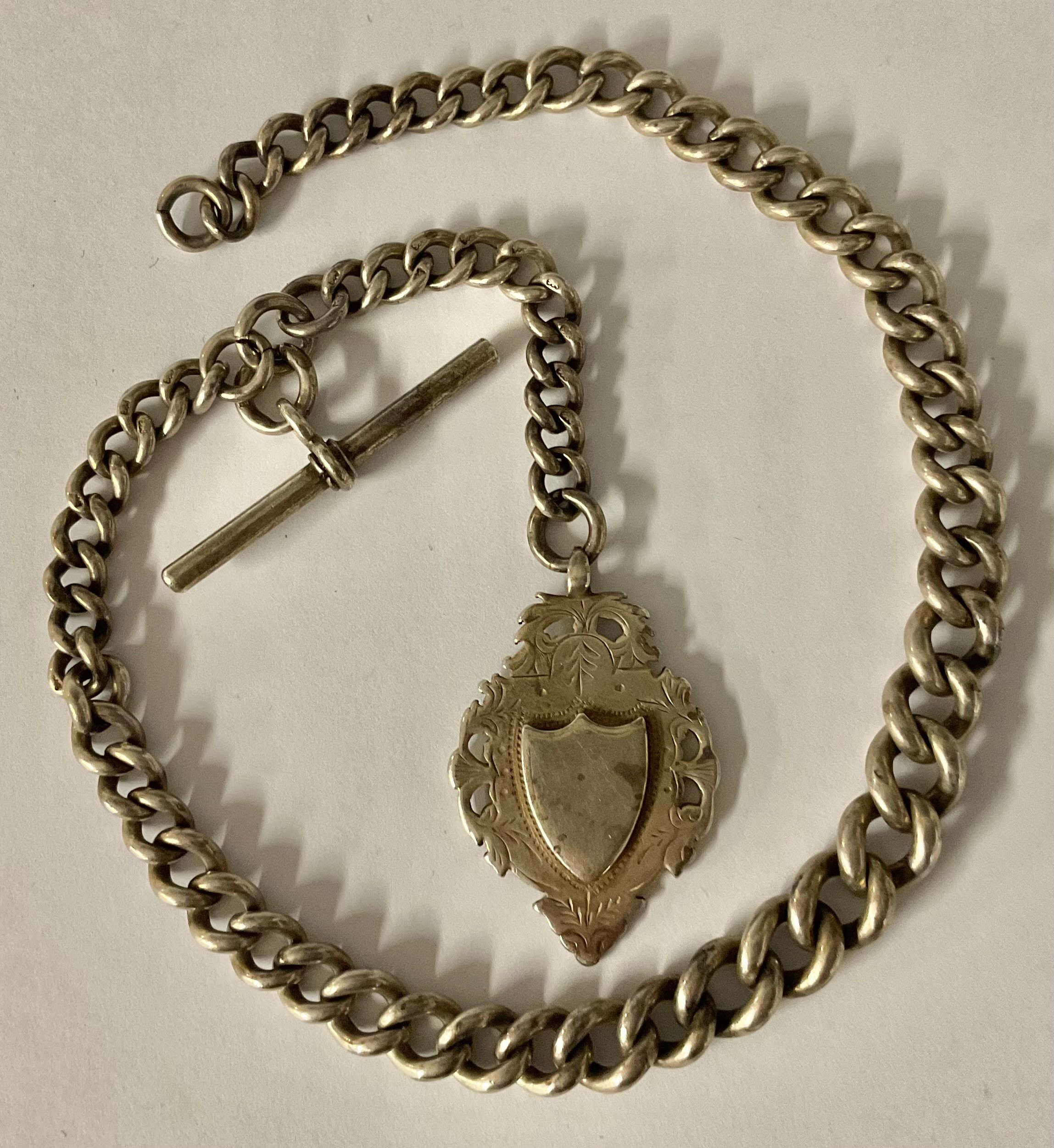 A Victorian silver graduated curb link Albert chain, with T-bar and shield fob, the fob Birmingham