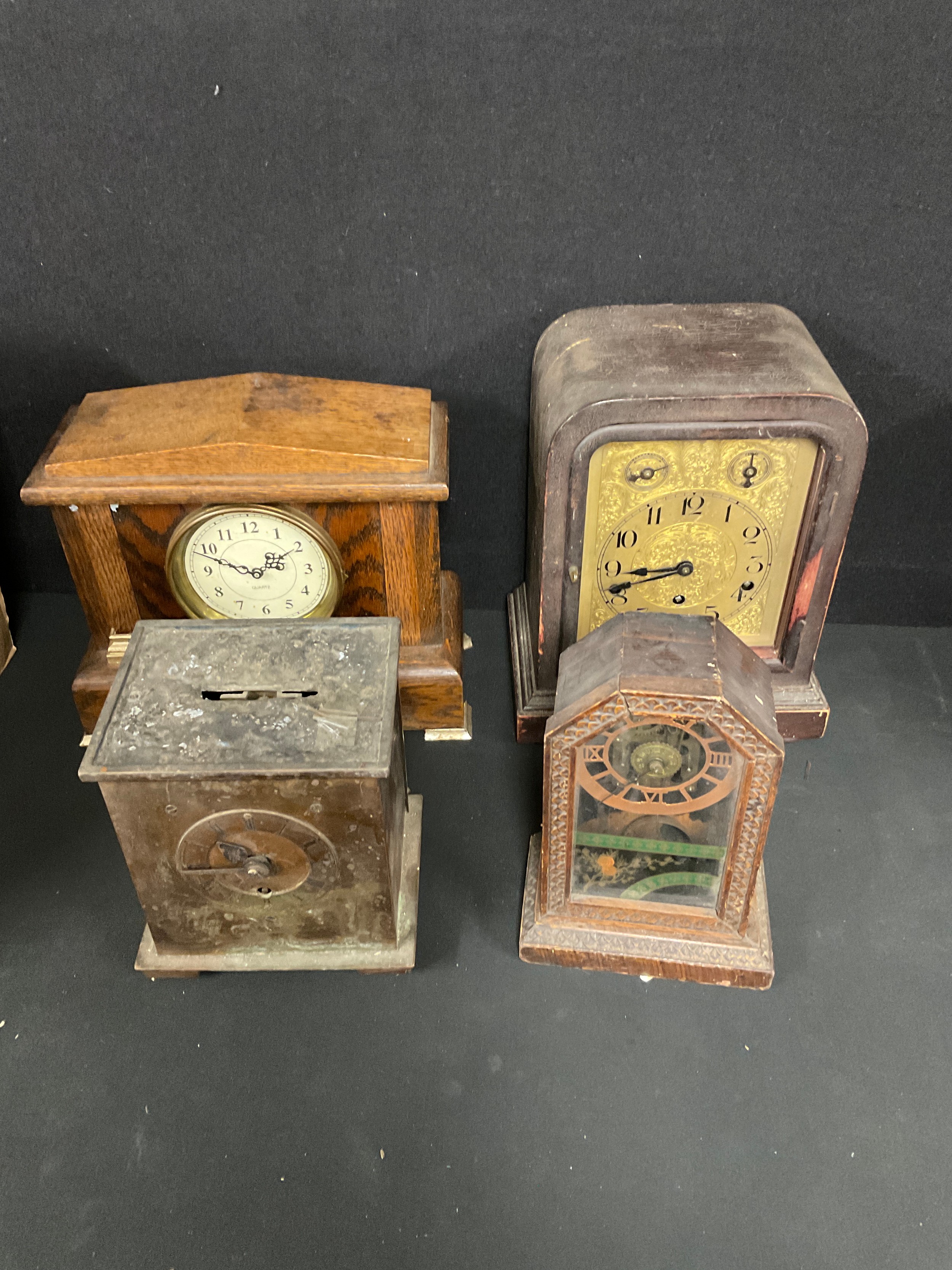 Clocks - an early 20th century oak mantel clock, Roman numerals on silvered dial, flanked by