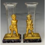 A pair of continental style vases, the gilt metal supports cast as a pair of putti holding Greek