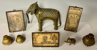 A 19th century brass Indian elephant, 17cm high; another similar, smaller; three brass Indian claw