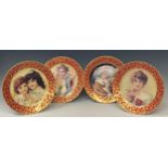 A set of four reproduction pictorial plates, each decorated with a red and gilt border, printed mark