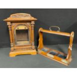 An oak bracket clock case, arched pediment with carved frieze, pair of turned column supports,
