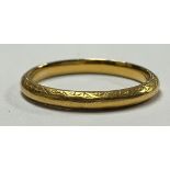 A 22ct gold wedding band, engraved with two bands of scrolls, size L, 2.8g, boxed