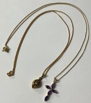 A 9ct gold amethyst cross pendant, 9ct gold necklace chain, marked 375, 2.8g, boxed; a 9ct gold ruby