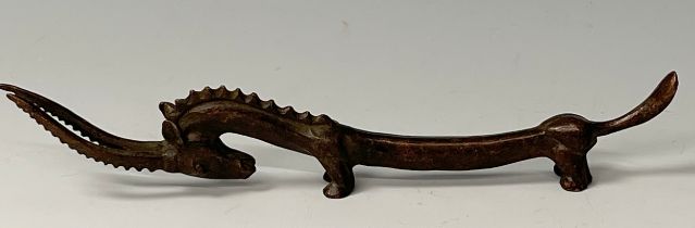 A bronzed metal figure of an elongated Gazelle, modelled in the Archaic taste, signed, 19cm long