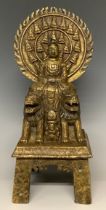 A 'bronzed' gilt metal figure of Buddha Shakyamuni, seated, 29.5cm high