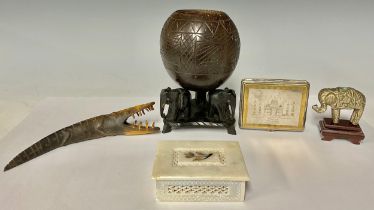 An Indian elephant coconut cup, tripod feet, 19cm high; a mother of pearl inlaid alabaster box; a
