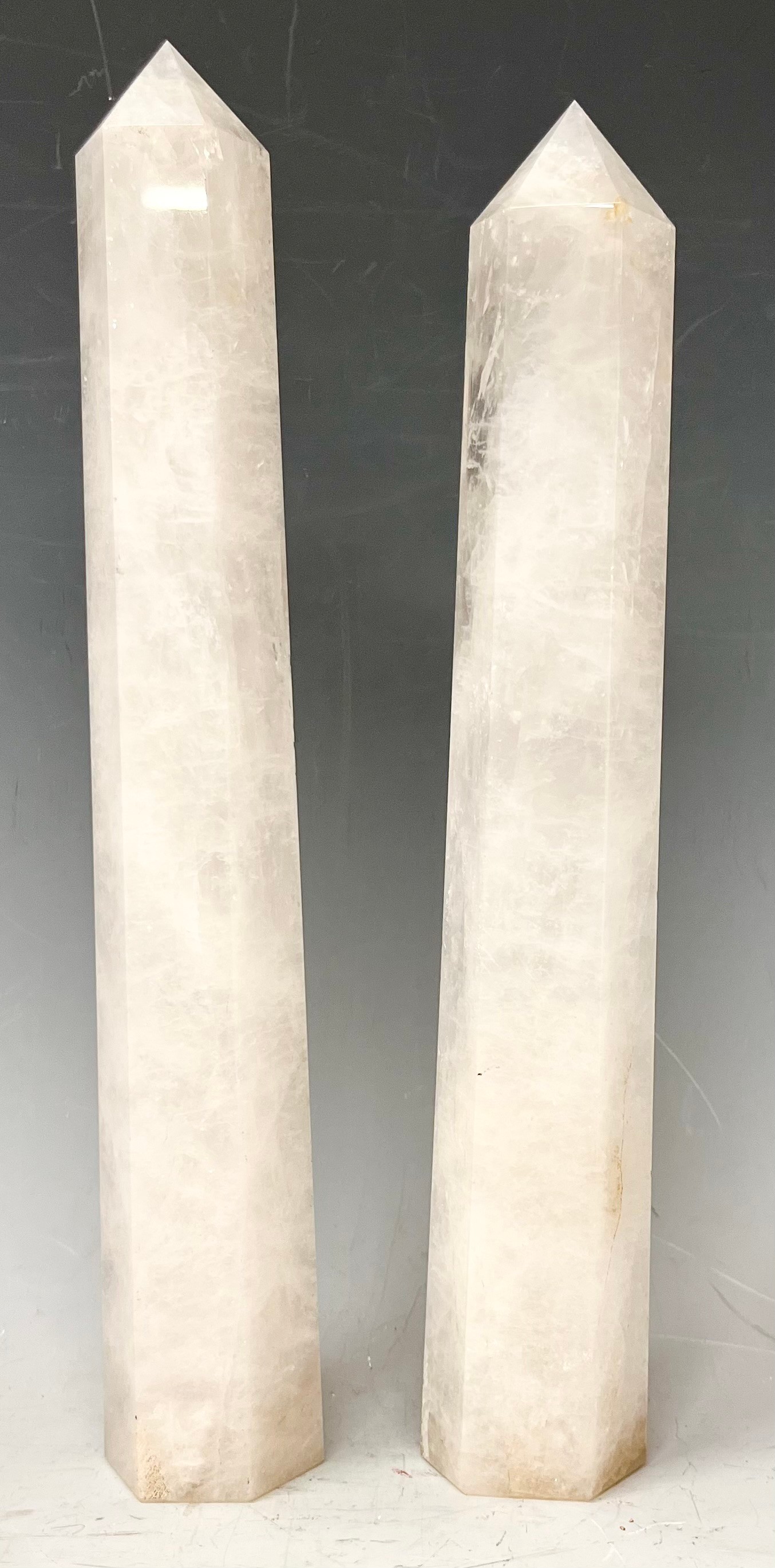 A pair of Rock crystal white quartz obelisks of slightly tapering hexagonal form, 29.5cm high and