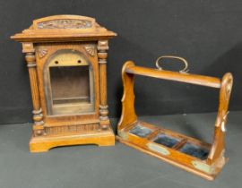 An oak bracket clock case, arched pediment with carved frieze, pair of turned column supports,