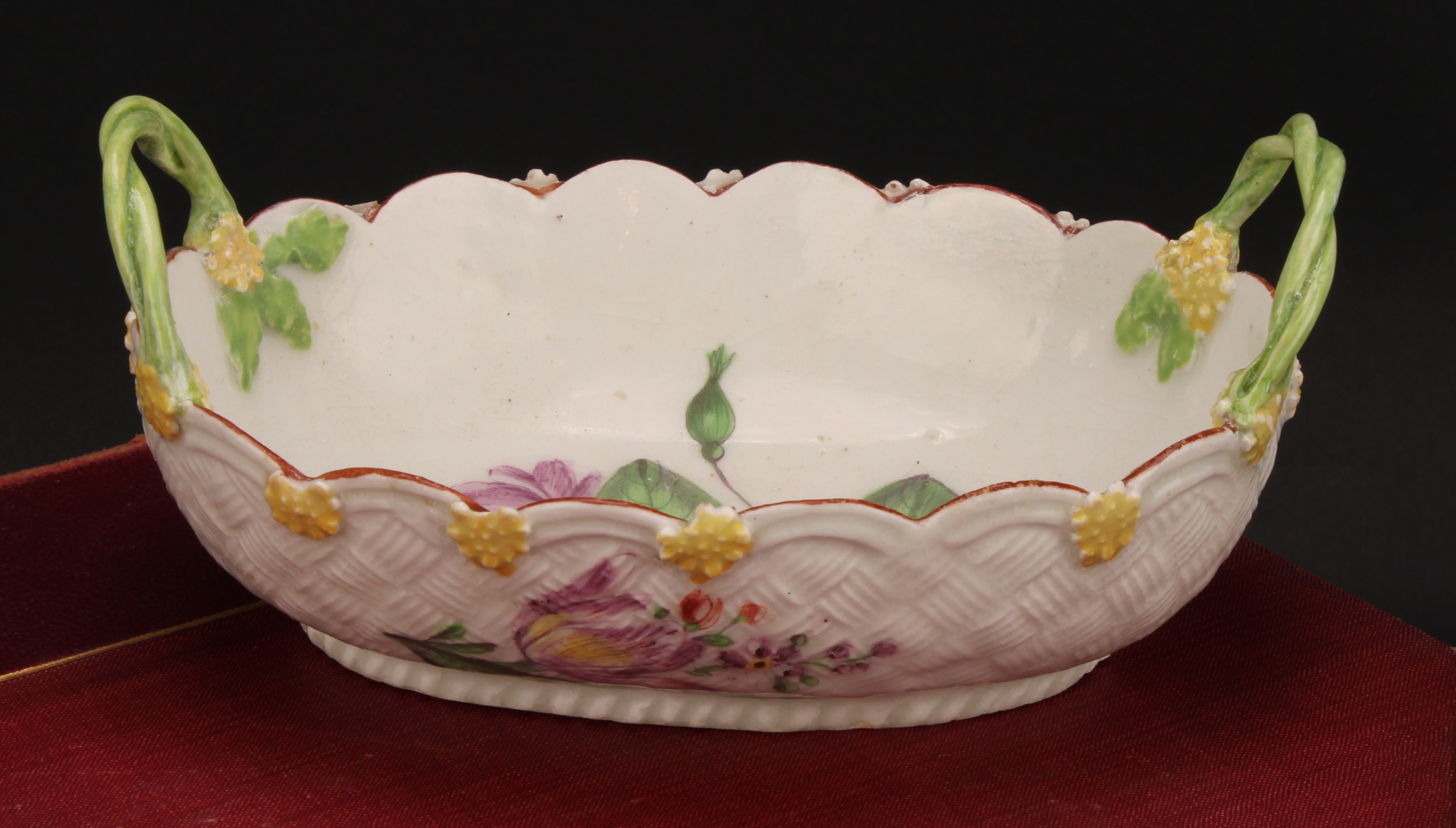 A Chelsea two-handled basket, painted with flowers, the exterior with basket weave moulding and