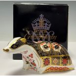 A Royal Crown Derby paperweight, Old Imari Badger, gold stopper, 15cm long, printed marks in red,