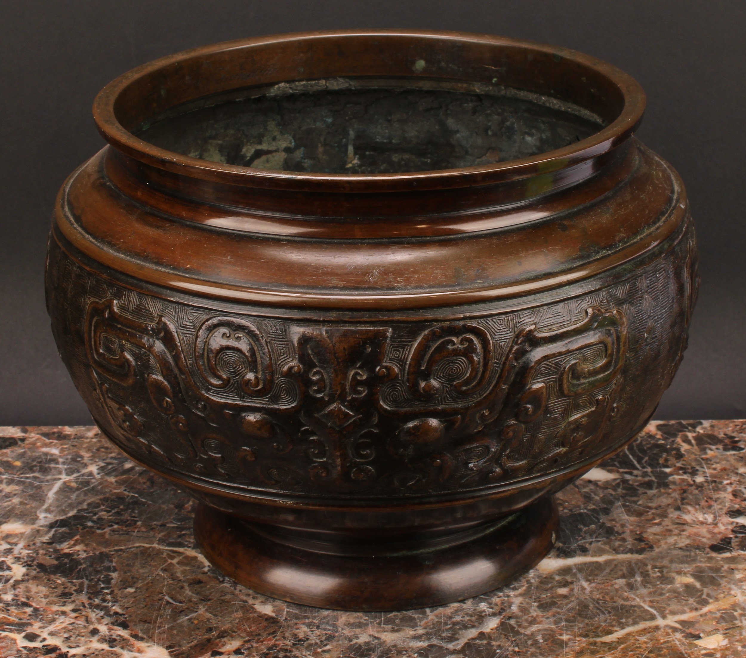 A Chinese patinated bronze ovoid pedestal jardiniere, relief decorated in the Archaic taste, 21cm - Image 2 of 3