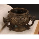A Chinese bronze hanging censer, pierced and cast with dragons, temple lions and scrolls, 18.5cm