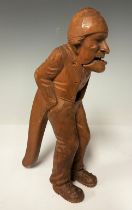 A late 19th century Swiss nutcracker, as a standing gentleman in nightcap, hands in his pockets, the