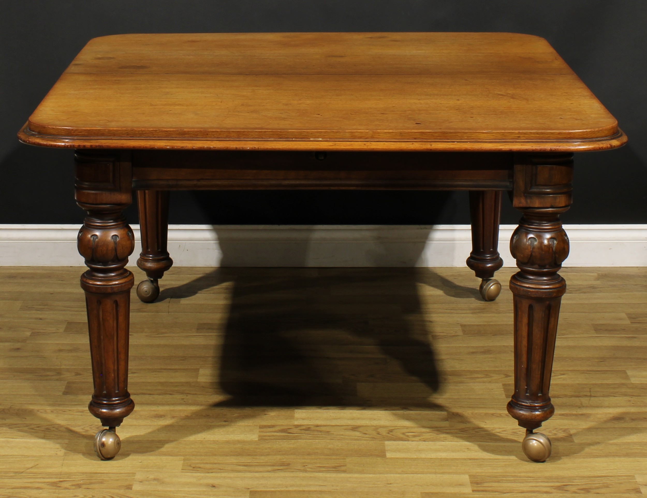 A Victorian walnut and mahogany extending dining table, rounded rectangular top with one - Image 3 of 3