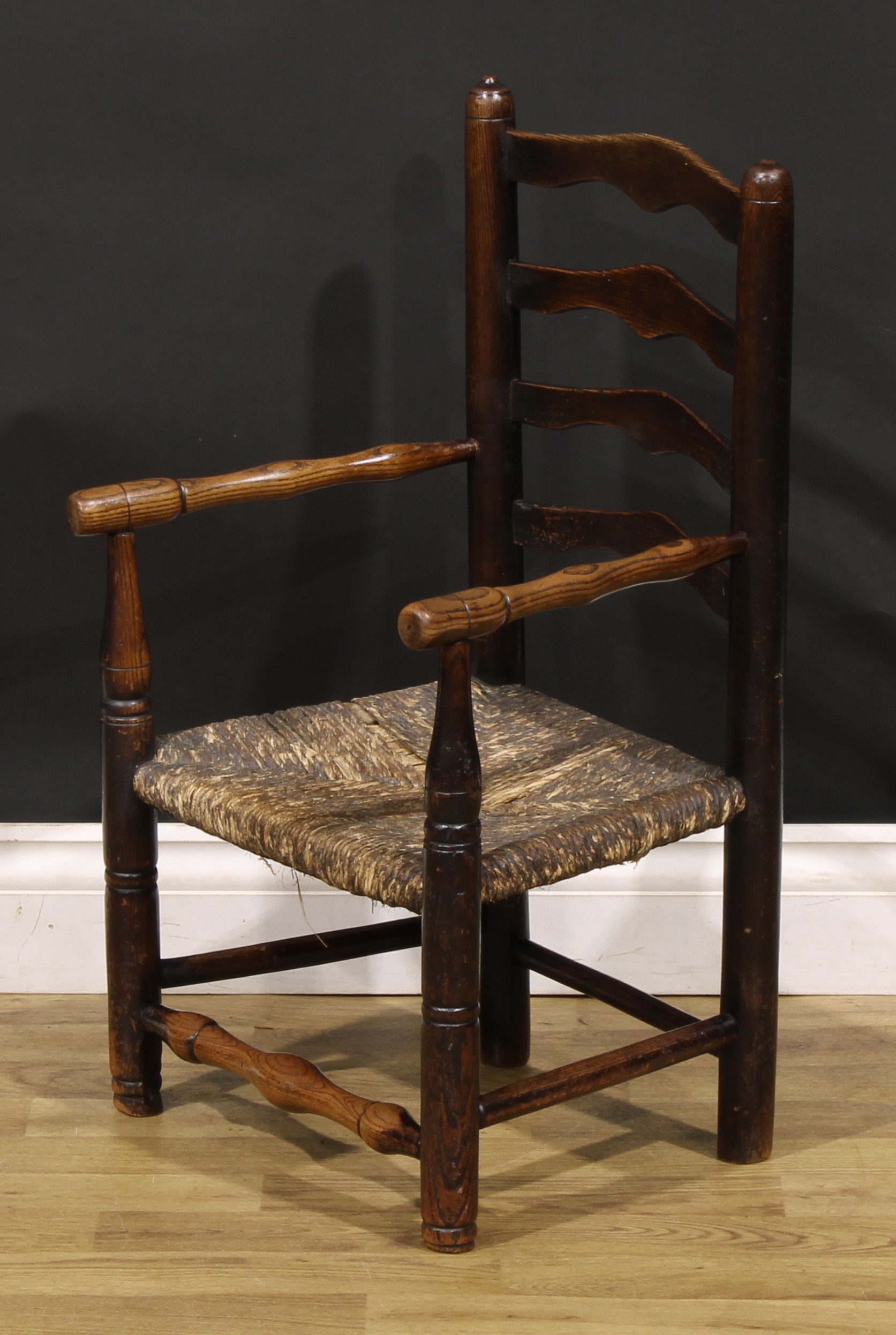 A 19th century elm child's chair, shaped ladder back, turned arms, legs and stretchers, rush seat, - Image 3 of 4