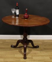 A George III mahogany birdcage tripod supper table, one-piece circular tilting top, baluster column,