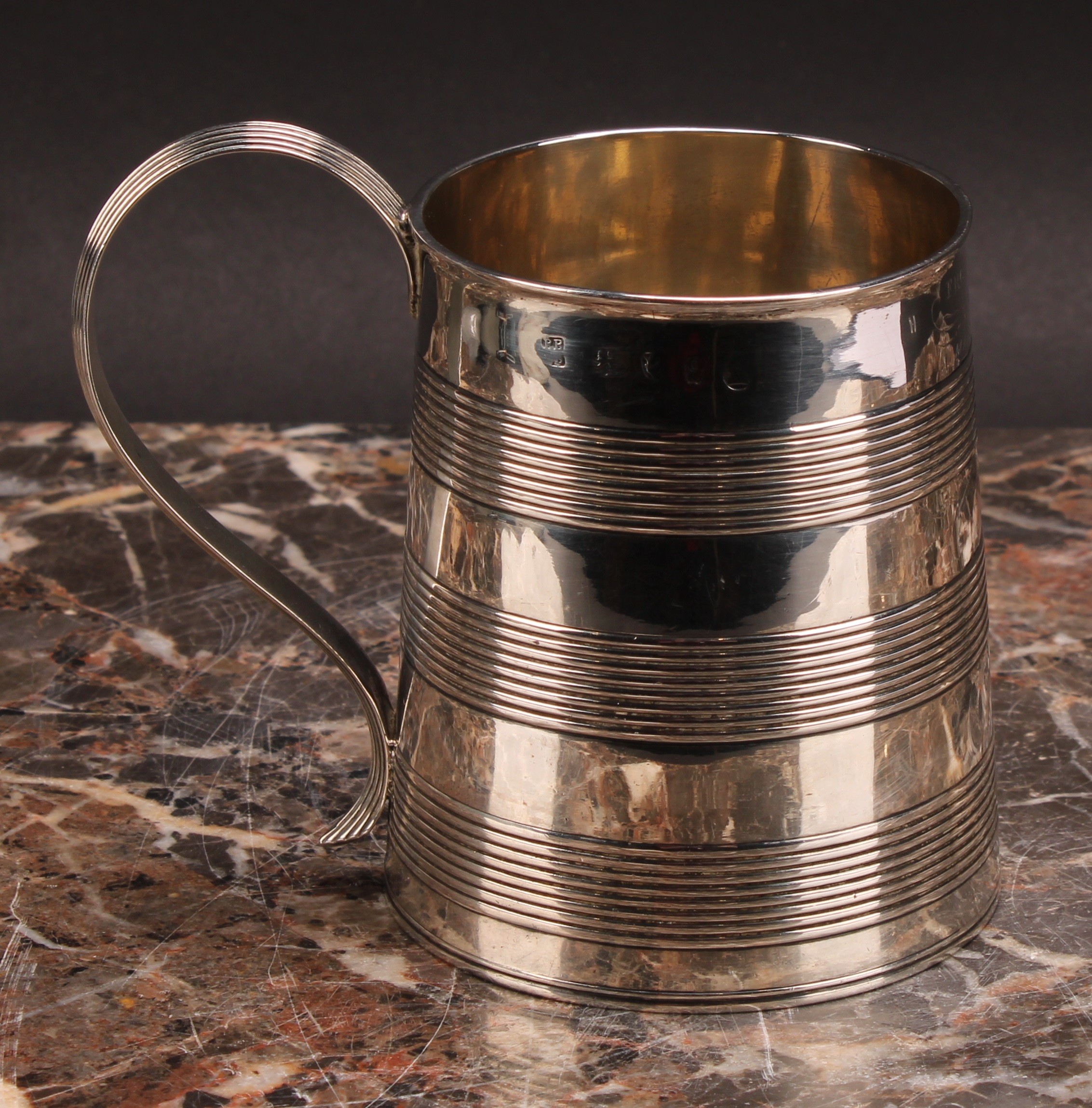 The Bateman Family -a George III silver spreading cylindrical mug, reeded bands and scroll handle,