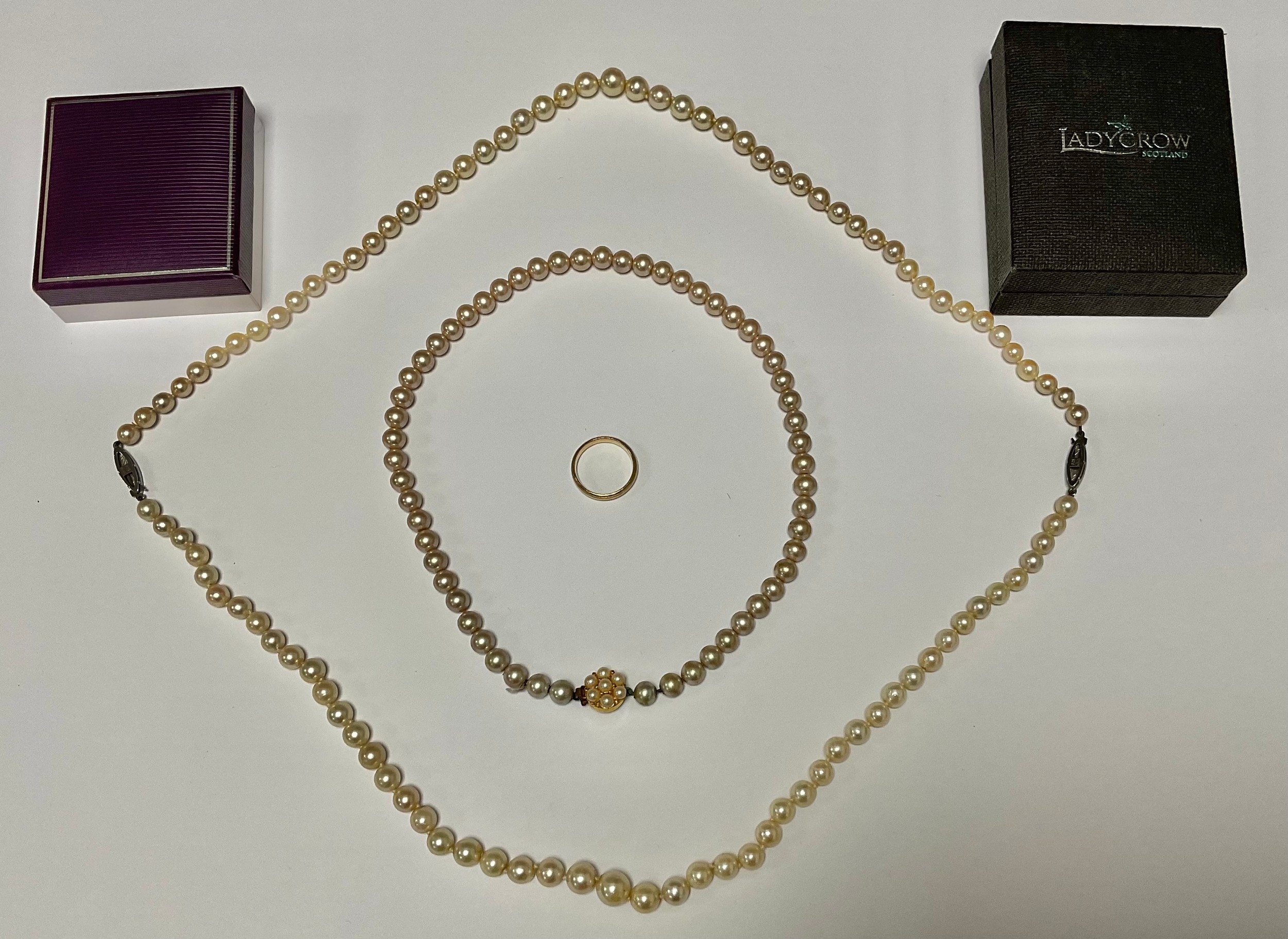 A 9ct gold wedding band, ring size O, 3.1g; a double strand cultured pearl necklace, each clasp