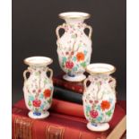 An English porcelain garniture, of two-handled ovoid vases, probably Spode, painted in the Chinese