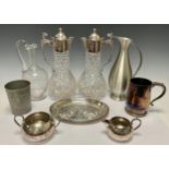 Silver Plate & Glass - A pair of cut glass claret jugs mounted with EPNS collar and lid, C-scroll