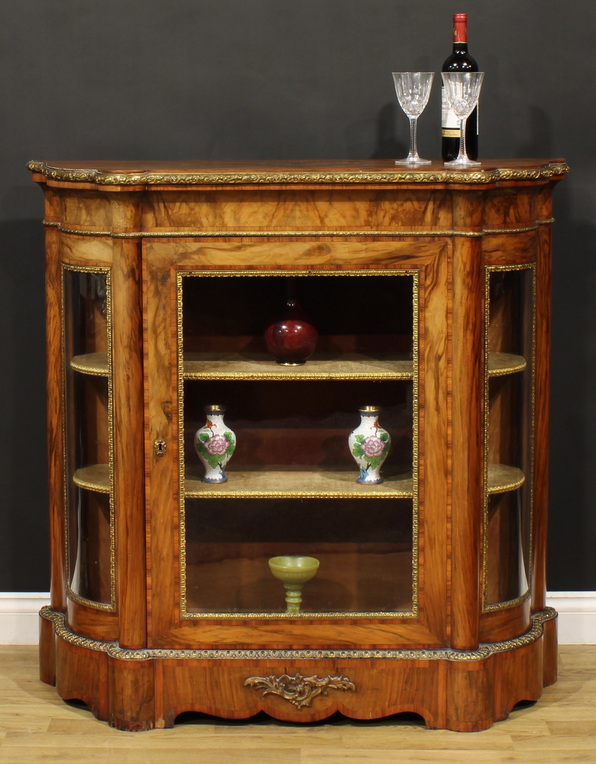 A Victorian gilt metal mounted rosewood crossbanded walnut credenza, oversailing top above a