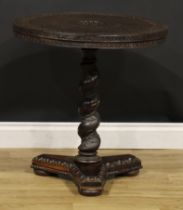 A 19th century Indian hardwood pedestal occasional table, circular top carved with deity,