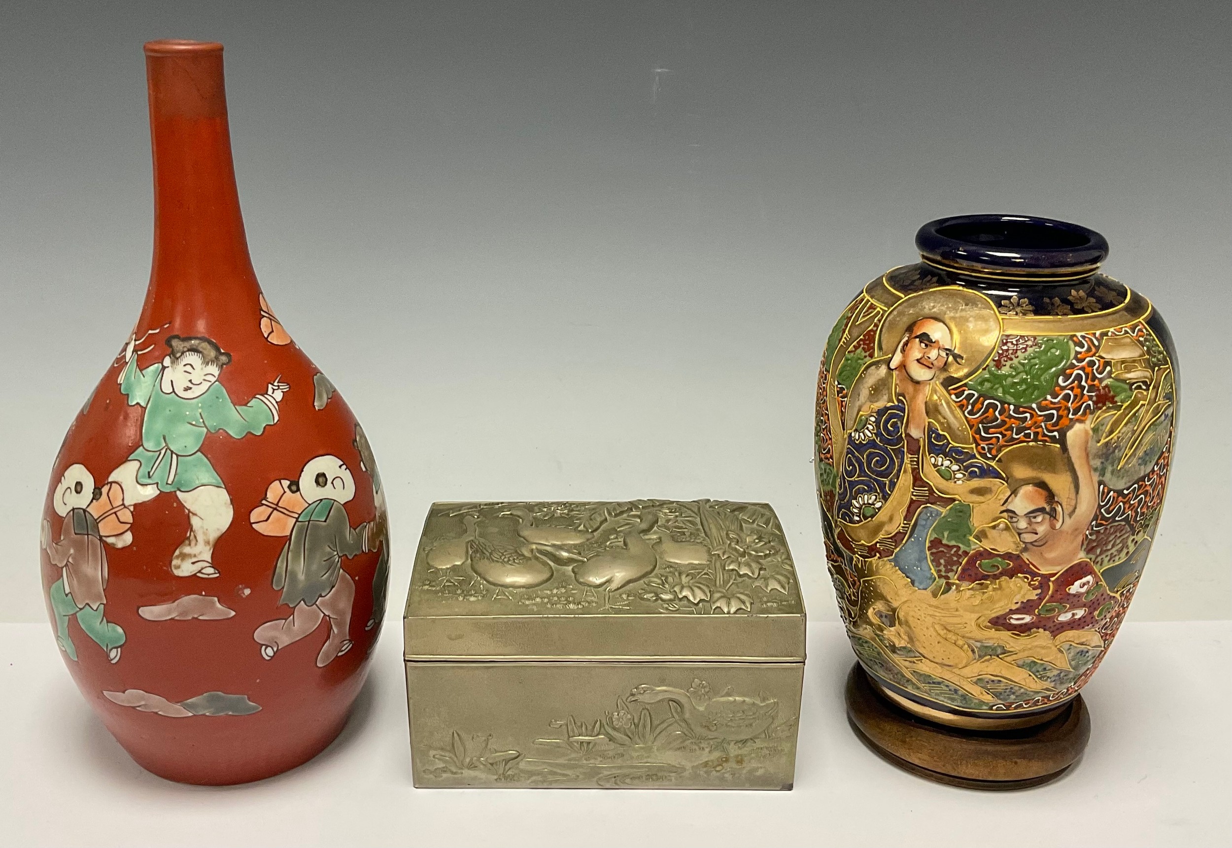 A Japanese cast metal box, hinged cover, applied with geese in a tropical landscape, 12.5cm wide;