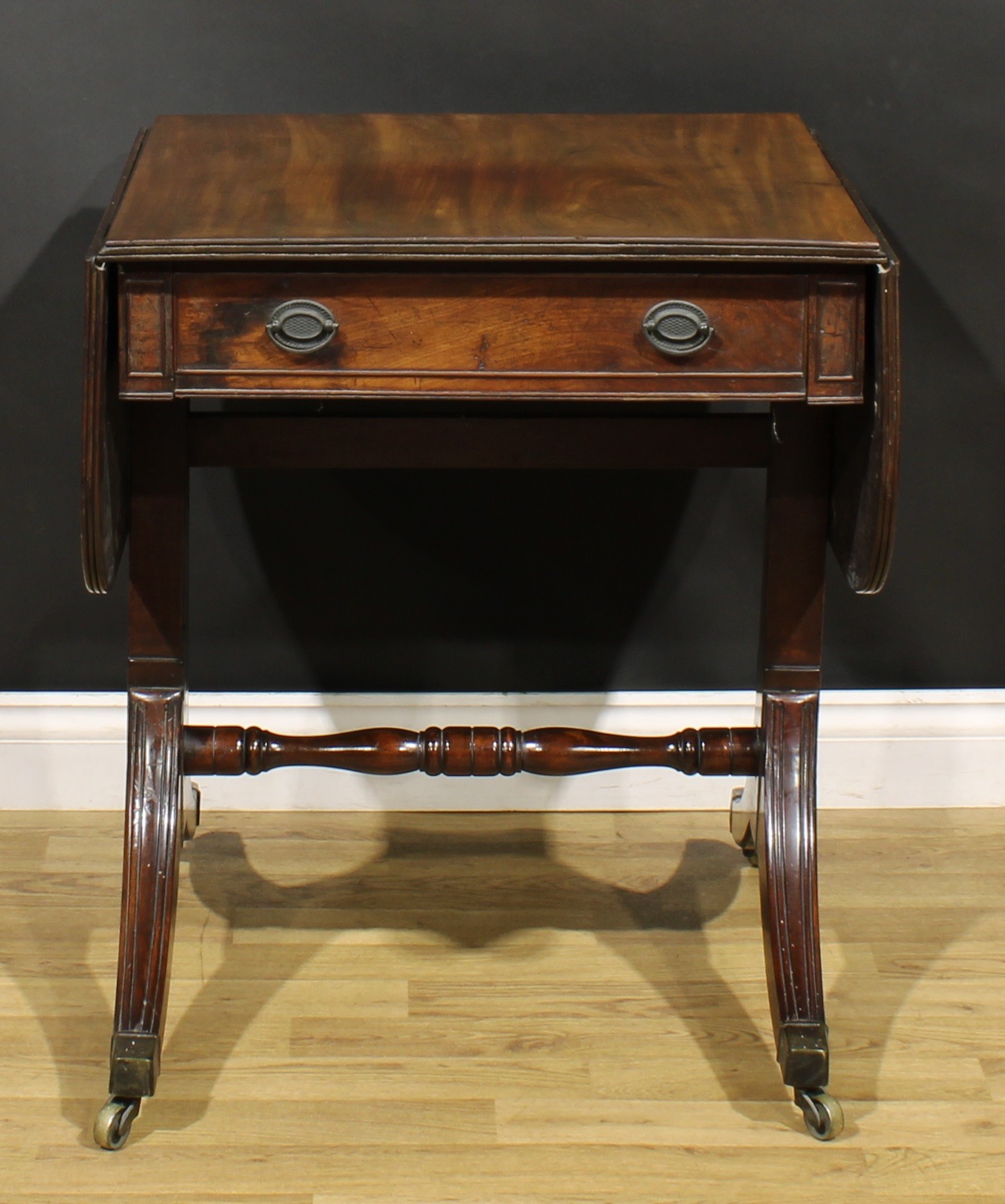 A 19th century mahogany sofa table, rounded rectangular top with fall leaves above a frieze - Image 7 of 7
