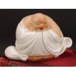 A Chinese pottery figure, of Budai, seated, 19cm high