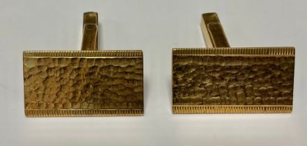 A pair of 9ct gold rectangular textured cuff links, milled borders, London 1968, 10.4g