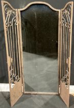 Interior Decoration - a large arched top rectangular wall mirror set behind a pair of metal garden