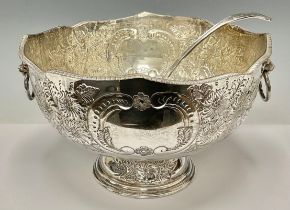 A large silver plated pedestal punch bowl, embossed with foliate scrolls, pair of lion mask loop