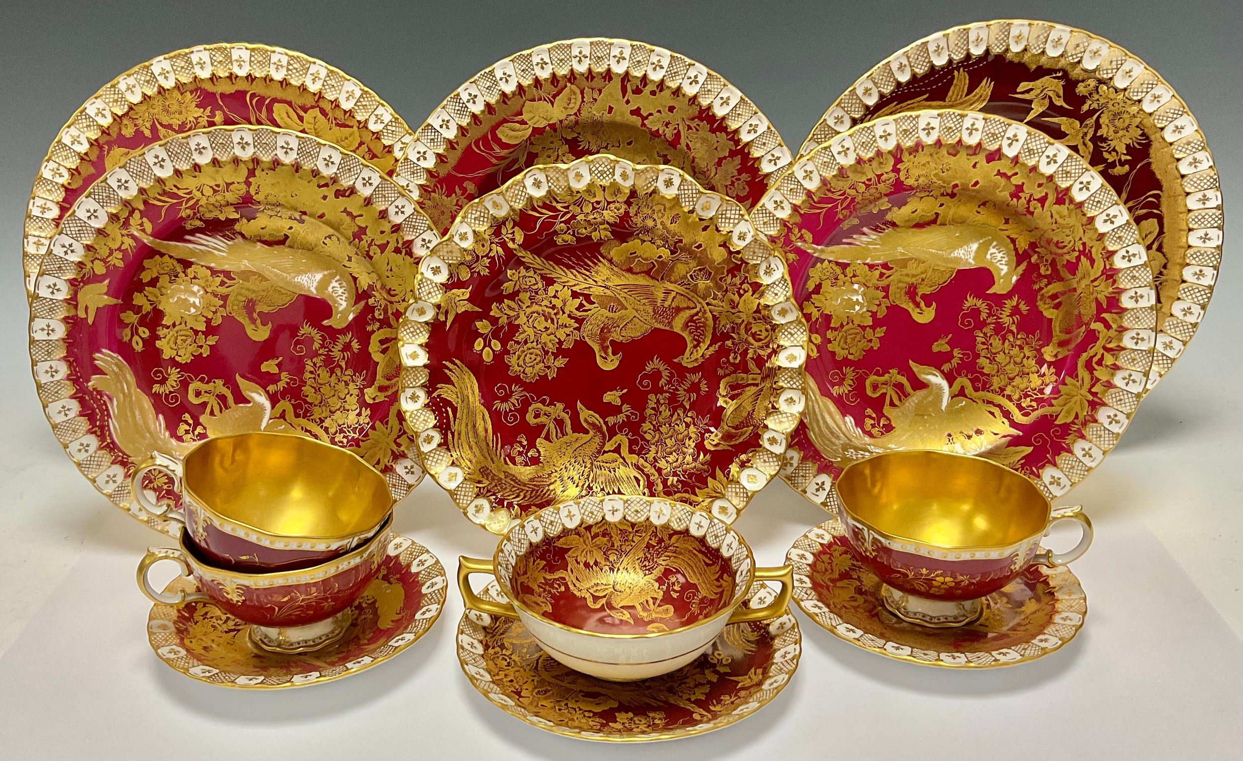 A Royal Crown Derby Red and Gold Aves pattern part dinner service, heraldic border, including soup