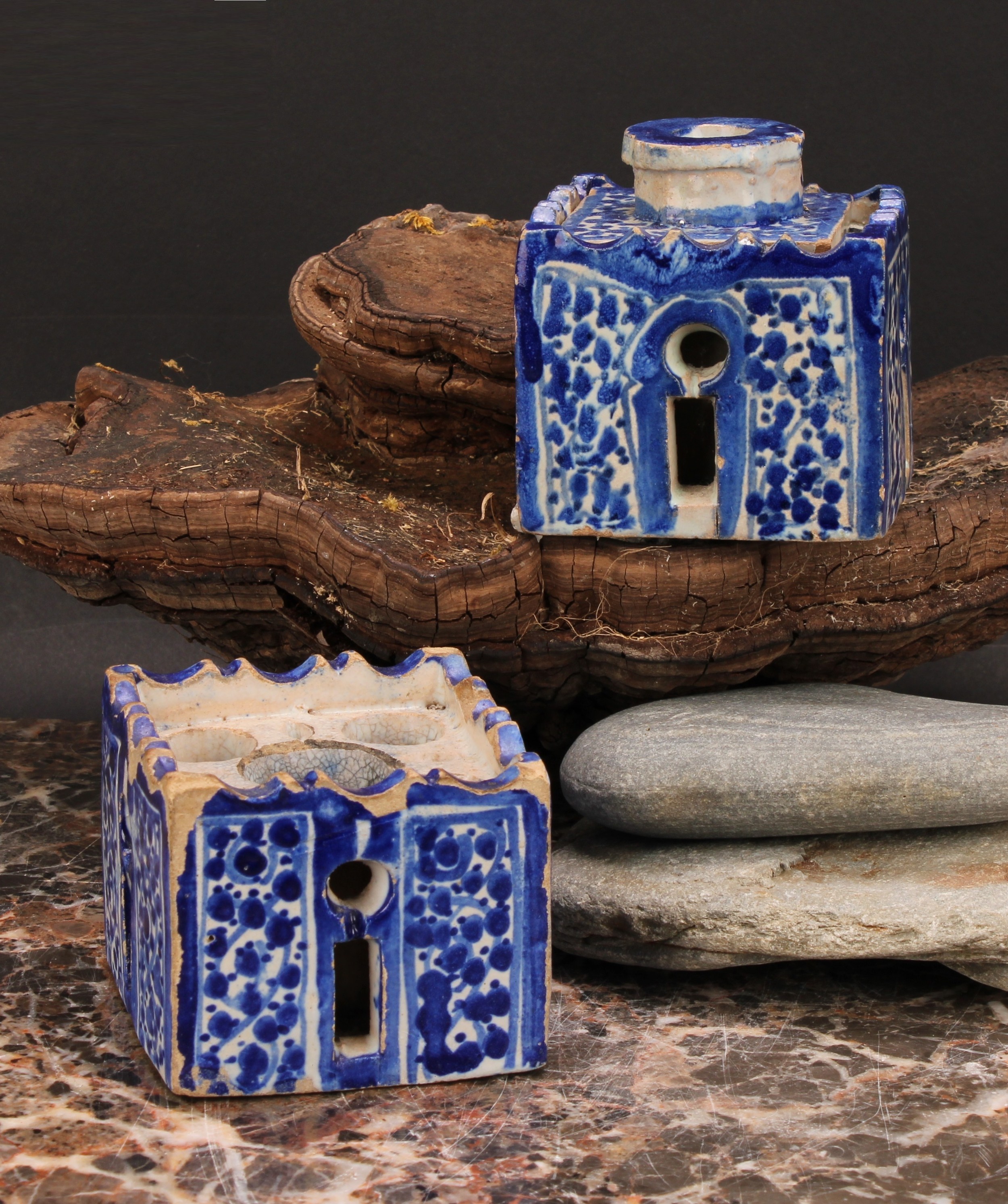 A 19th century Moroccan pottery inkwell and cover, in the form of a quba, painted in blue with