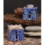 A 19th century Moroccan pottery inkwell and cover, in the form of a quba, painted in blue with