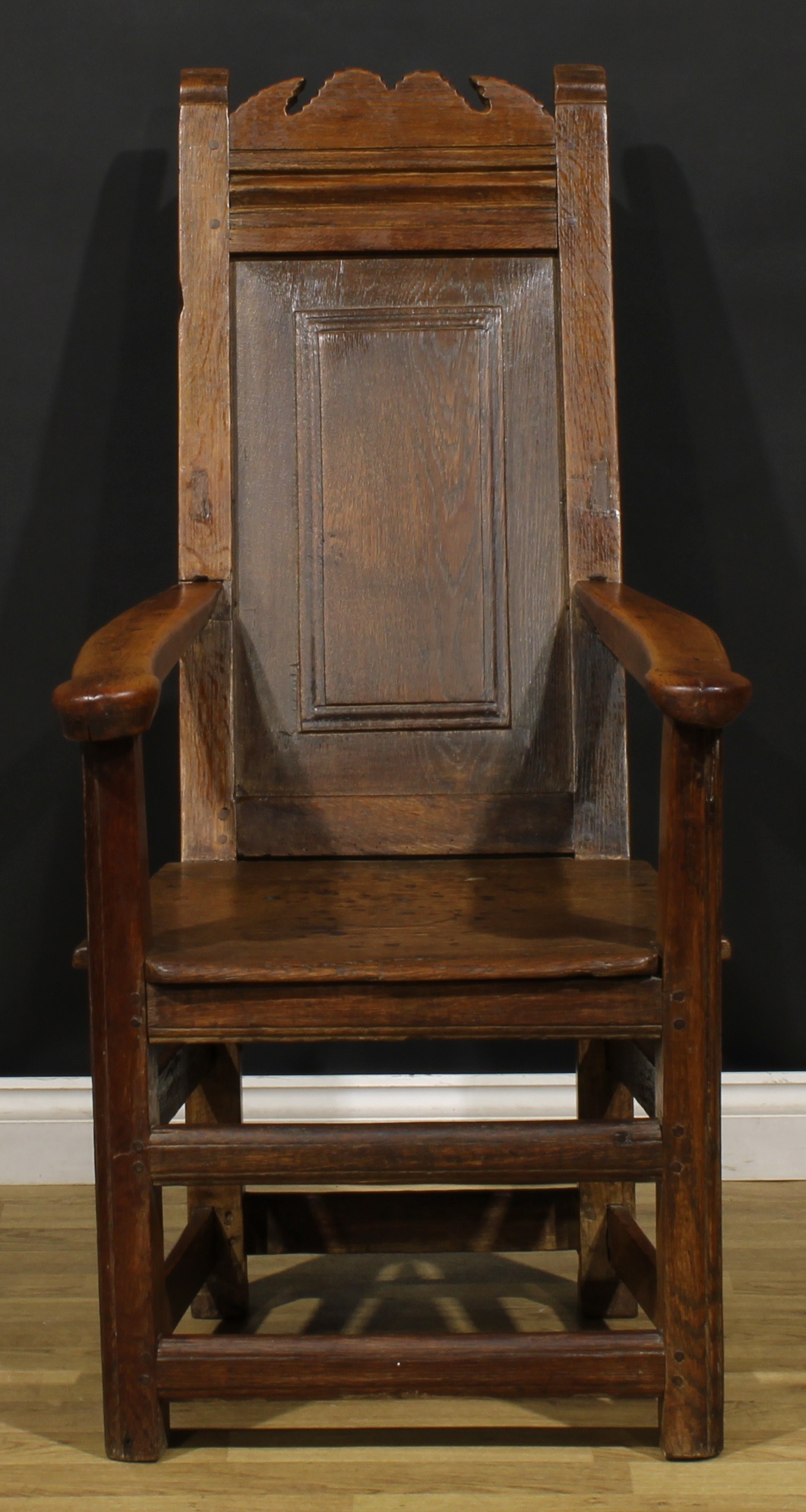 An 18th century and later oak and fruitwood caquetoire or panel-back armchair, possibly Scottish,