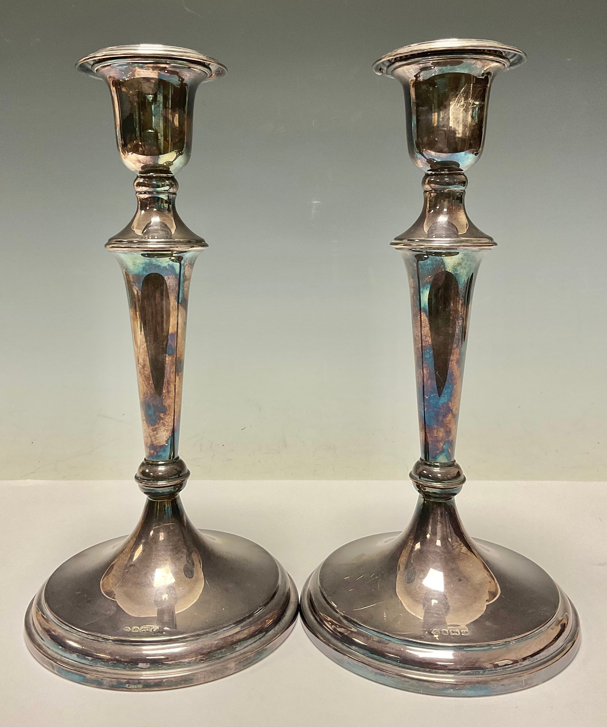 A pair of George III style silver round table candlesticks, knopped pillars, loaded, each 25cm high,