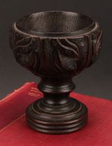 A 19th century oak goblet or chalice, the bowl carved with acanthus, turned base, 14cm high,
