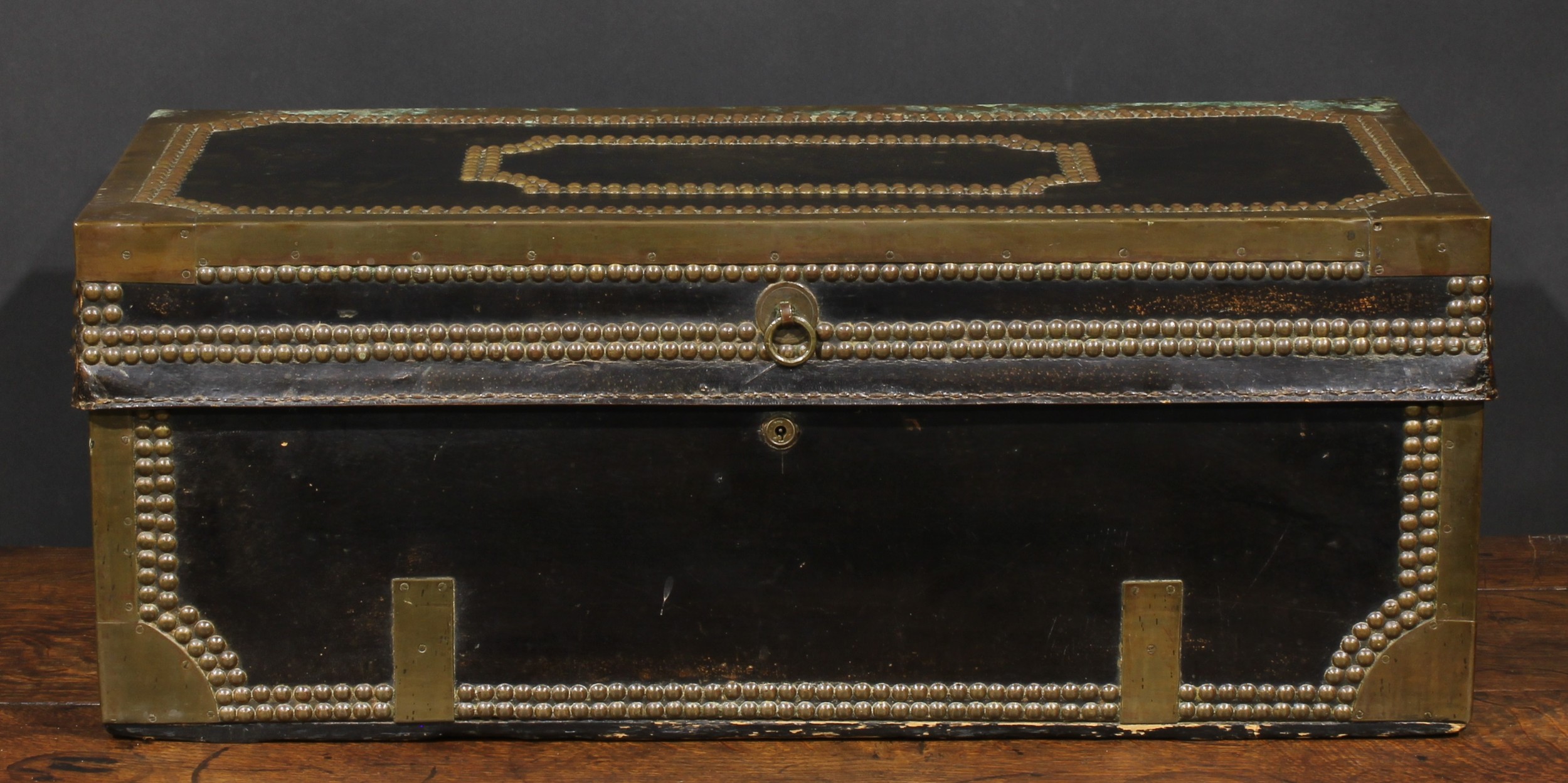 An early 19th century brass and studded leather mounted camphor travelling or coaching trunk, hinged