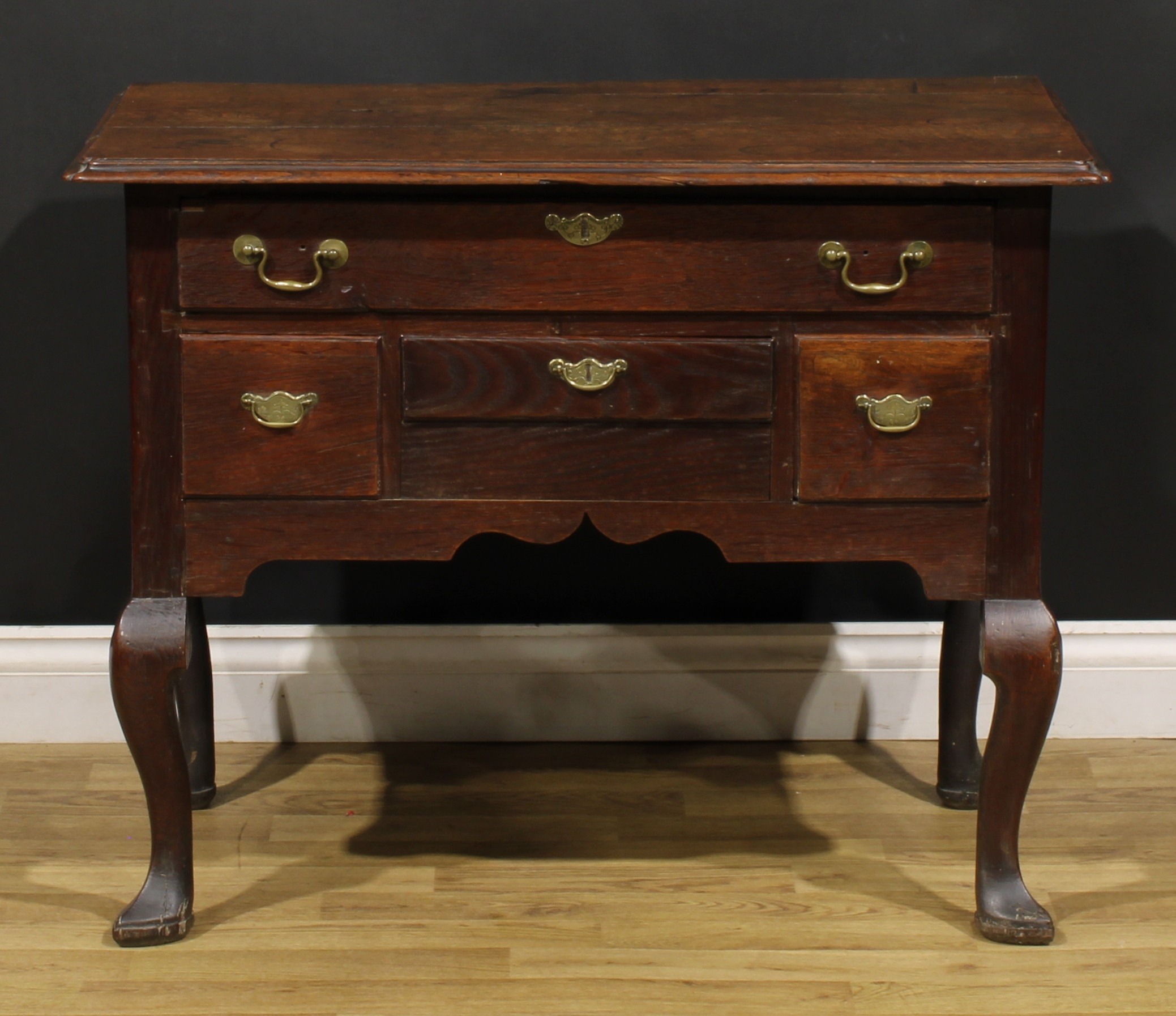 An 18th century oak lowboy, rectangular top with reentrant foreangles above four drawers, shaped - Image 2 of 6