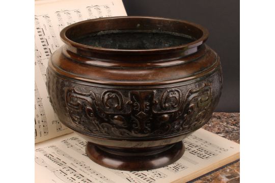 A Chinese patinated bronze ovoid pedestal jardiniere, relief decorated in the Archaic taste, 21cm - Image 1 of 3