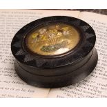 An early 19th century pressed horn waisted circular snuff box, the push-fitting cover decorated in