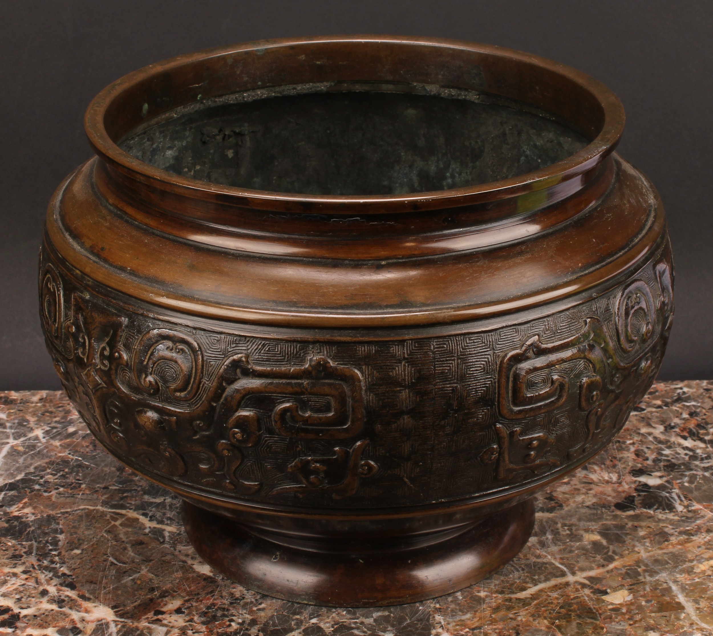 A Chinese patinated bronze ovoid pedestal jardiniere, relief decorated in the Archaic taste, 21cm - Image 3 of 3