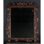 A Black Forest rectangular looking glass, carved with fruiting vine, bevelled mirror plate, 75cm